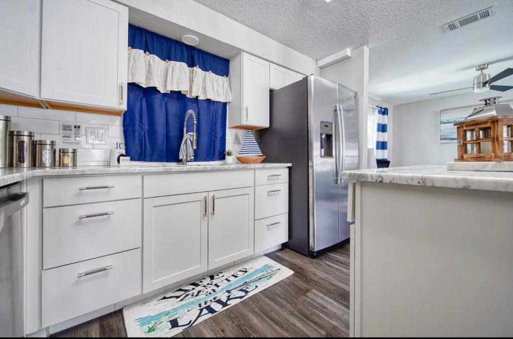 a kitchen with white cabinets and a refrigerator at Placeforus in Brooklyn