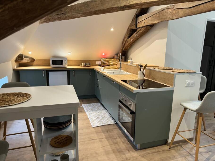 a kitchen with a sink and a counter top at Logement cocon in Chaudenay