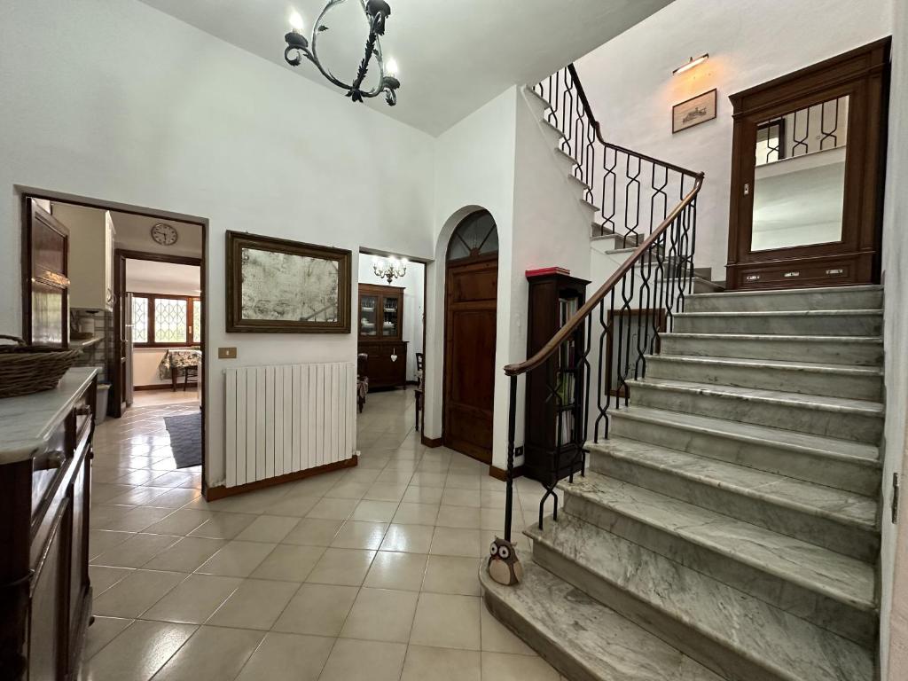a hallway with a staircase in a house at Villetta stile Liberty a Marina di Pisa in Marina di Pisa