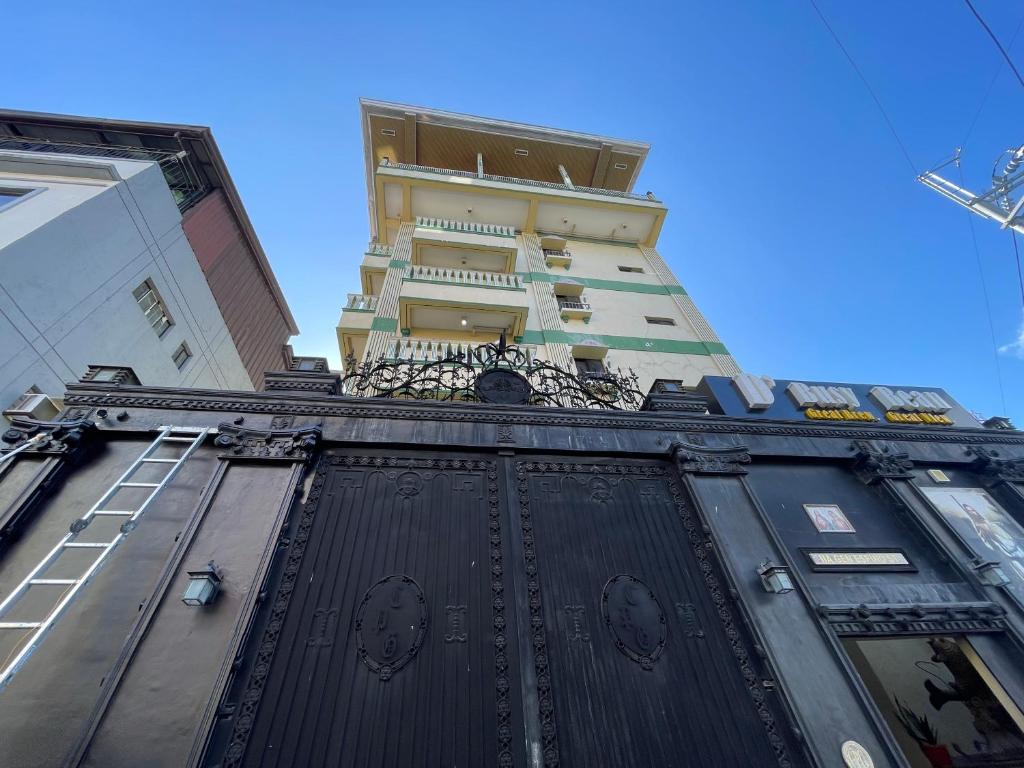 a tall building with a black door in front of it at Chanel Paris Hotel powered by Cocotel in Manila