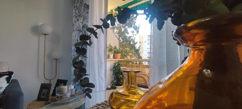 a yellow vase sitting on a table next to a window at Boquerón 5 in Torre del Mar