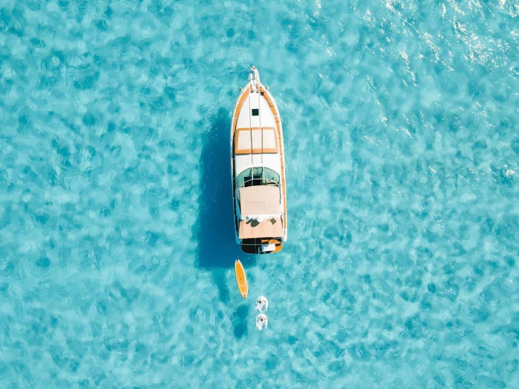 an overhead view of a boat in the blue water at Ocean Blue in Cancún