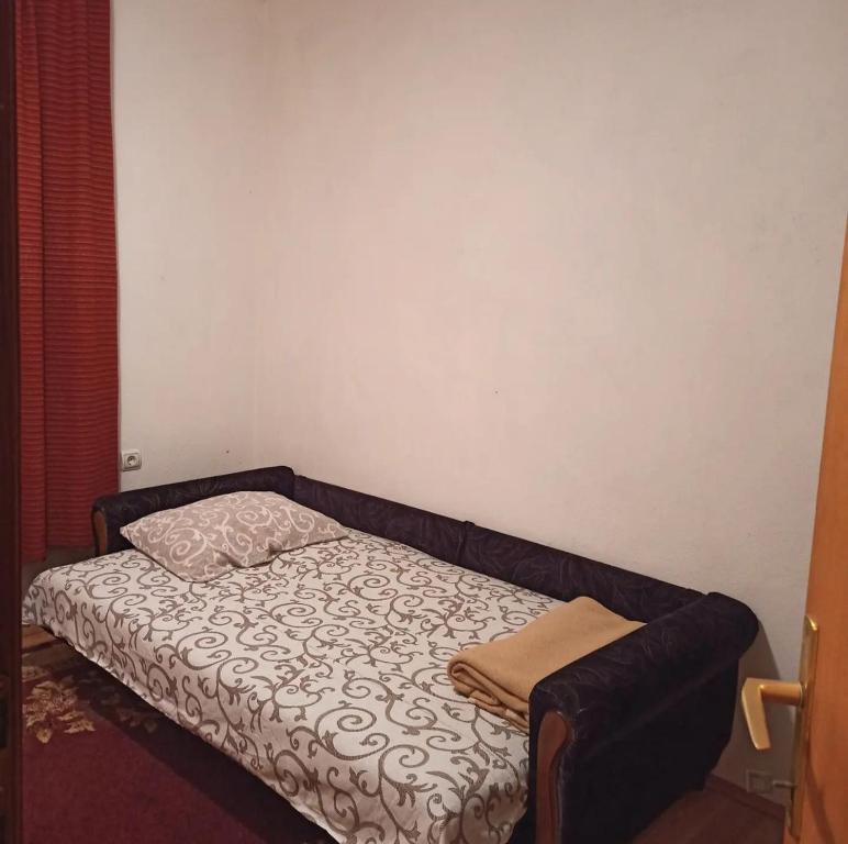 a small bed in a small room with a pillow at Drinska lepota in Ljubovija