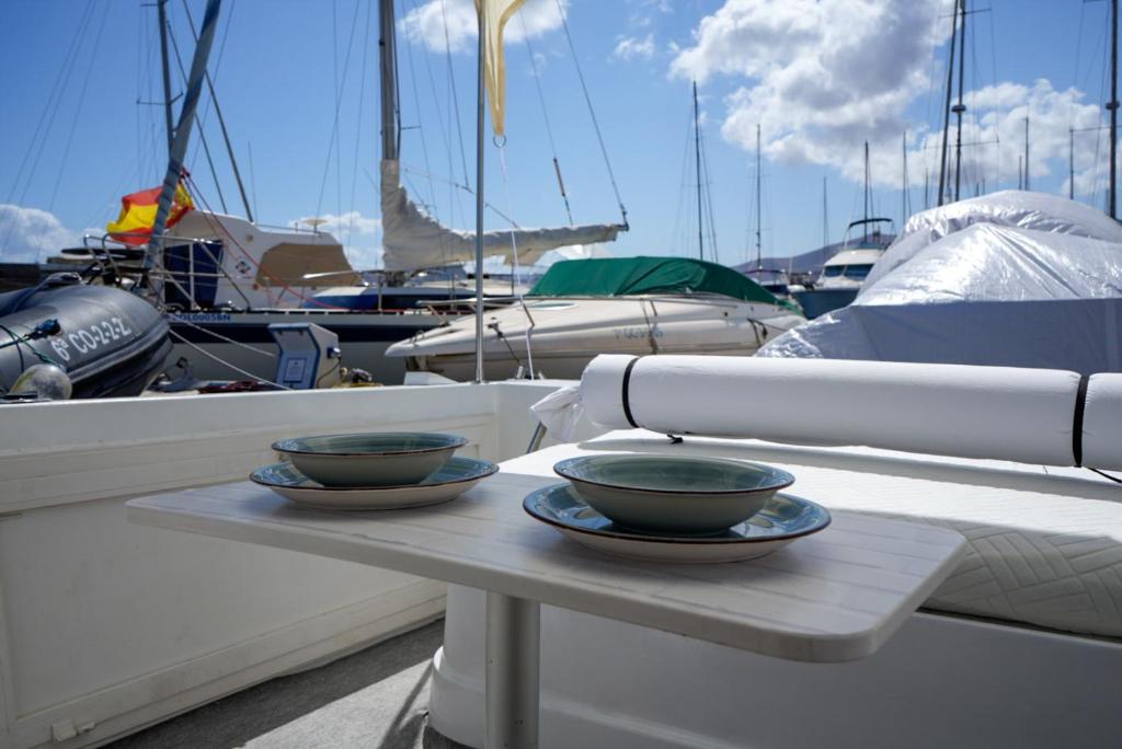 two bowls are sitting on a table on a boat at Night at sea Puerto Calero in Puerto Calero
