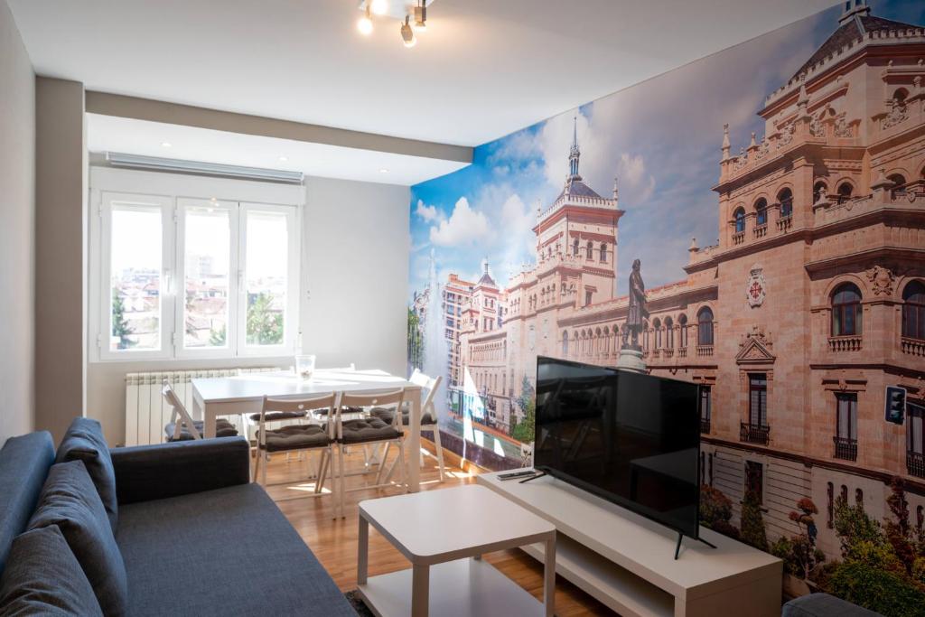 a living room with a wall mural of a building at Apartamento GO Felipe II Center in Valladolid