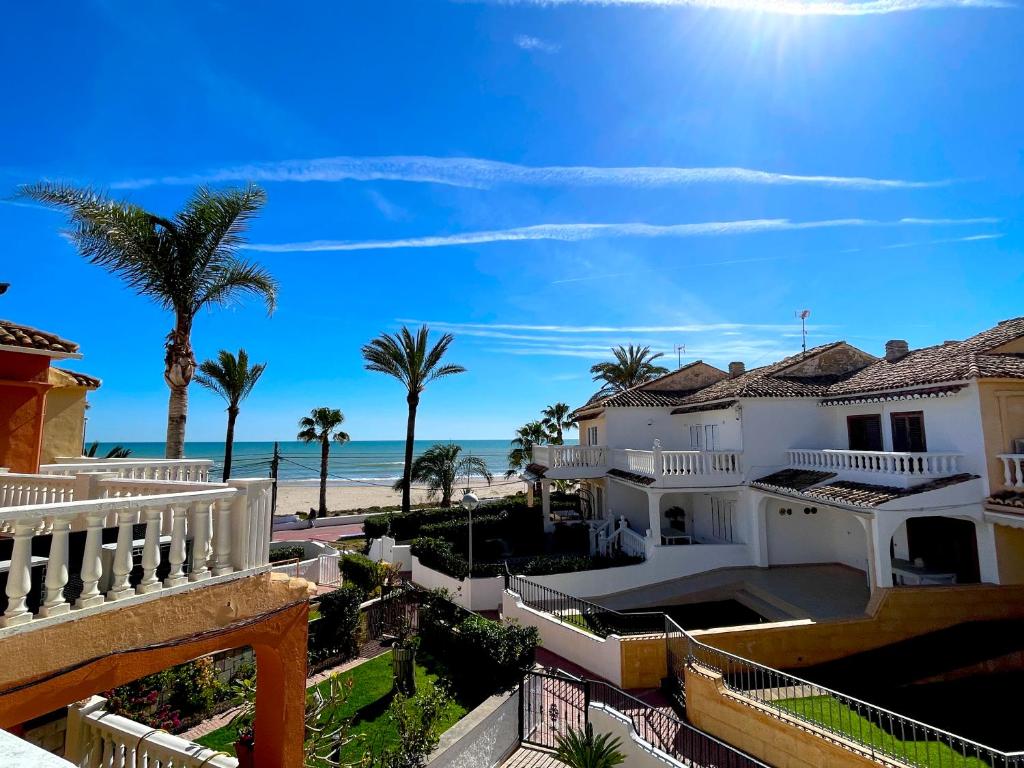 a view of the beach from the balcony of a house at Bungalow on the beach 15 minutes from Valencia in Valencia