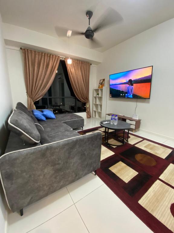 a living room with a couch and a flat screen tv at Homestay in Cheras
