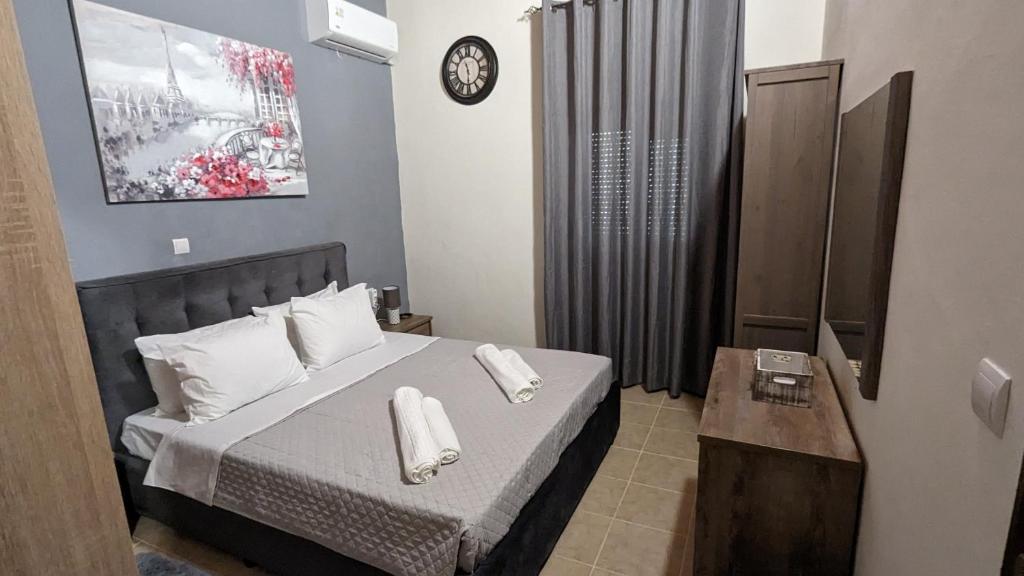 a bedroom with a bed with two towels on it at GIANNIS HOUSE in Rhodes Town