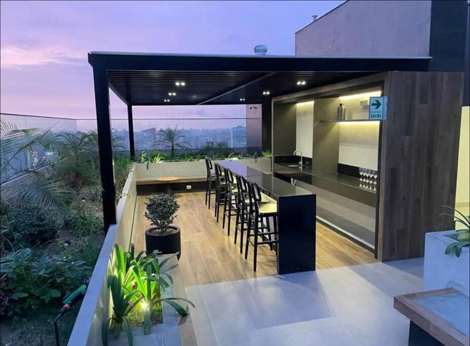 an outdoor kitchen and dining area of a house at San Isidro Estreno Luxury Apart Pool Gym 804SI in Lima