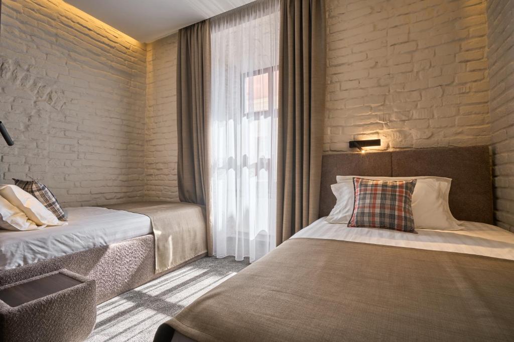Postel nebo postele na pokoji v ubytování FIMKA Apart Hotel