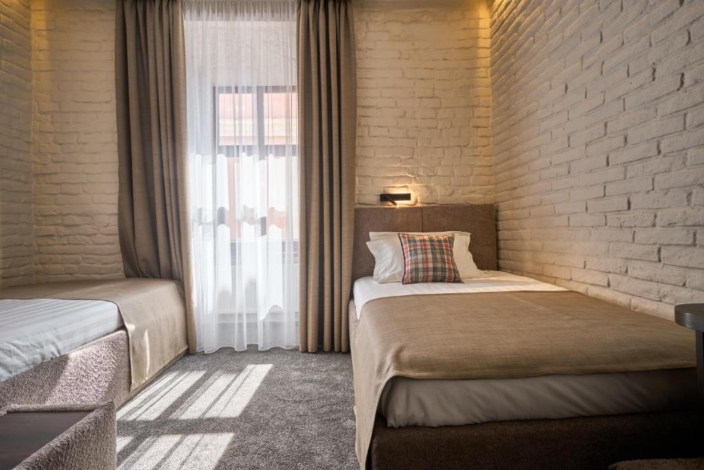 Postel nebo postele na pokoji v ubytování FIMKA Apart Hotel