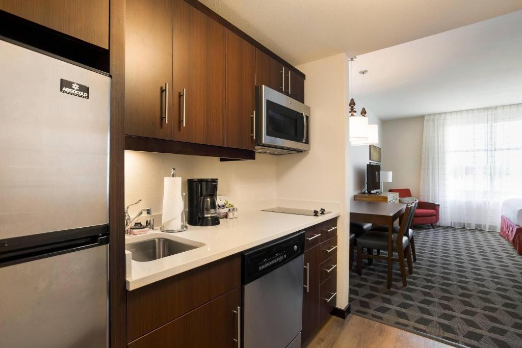 a small kitchen with a sink and a microwave at TownePlace Suites by Marriott San Mateo Foster City in Foster City