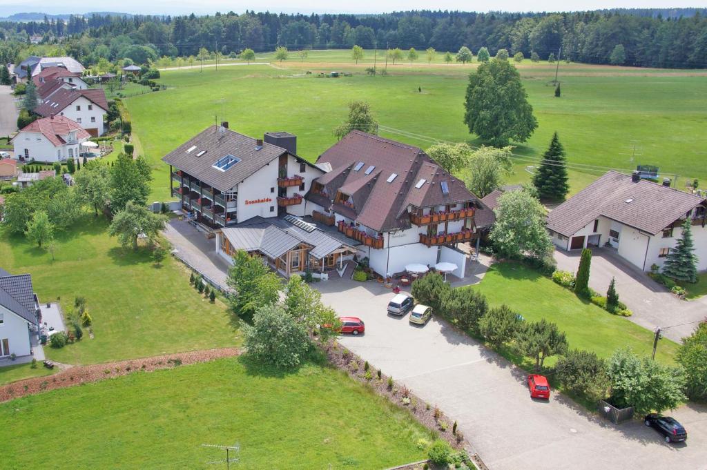 an aerial view of a large house with a parking lot at Wellnesshotel Sonnenhof & Sonnhalde in Ühlingen-Birkendorf