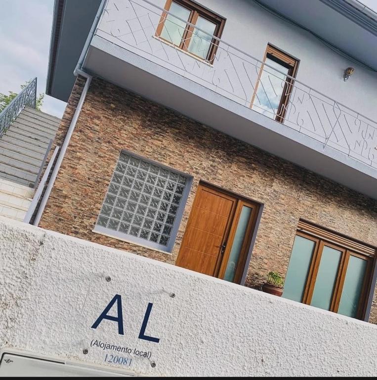 a building with a ak sign in front of it at Anjú-Pardal in Mogadouro