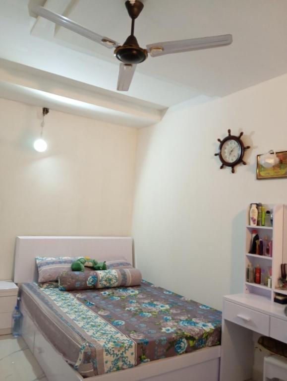 Schlafzimmer mit einem Bett und einem Deckenventilator in der Unterkunft Aaraasth in Vaadhoo