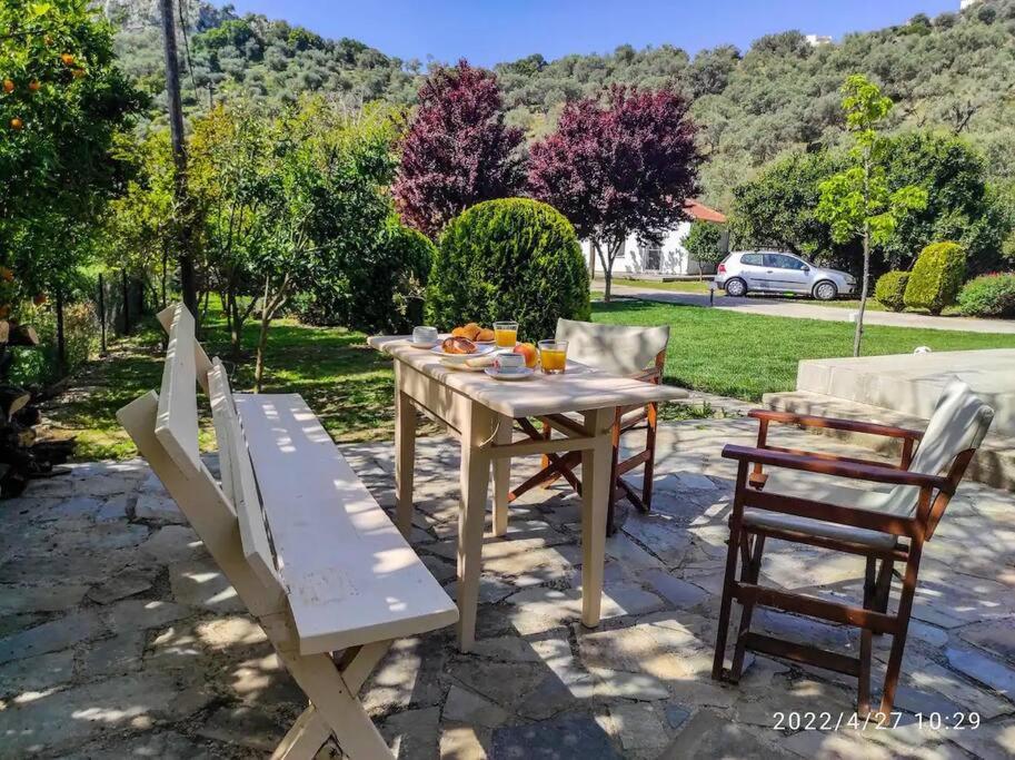 a table and chairs sitting on a stone patio at Garden Ηouse N°3 in Plomarion