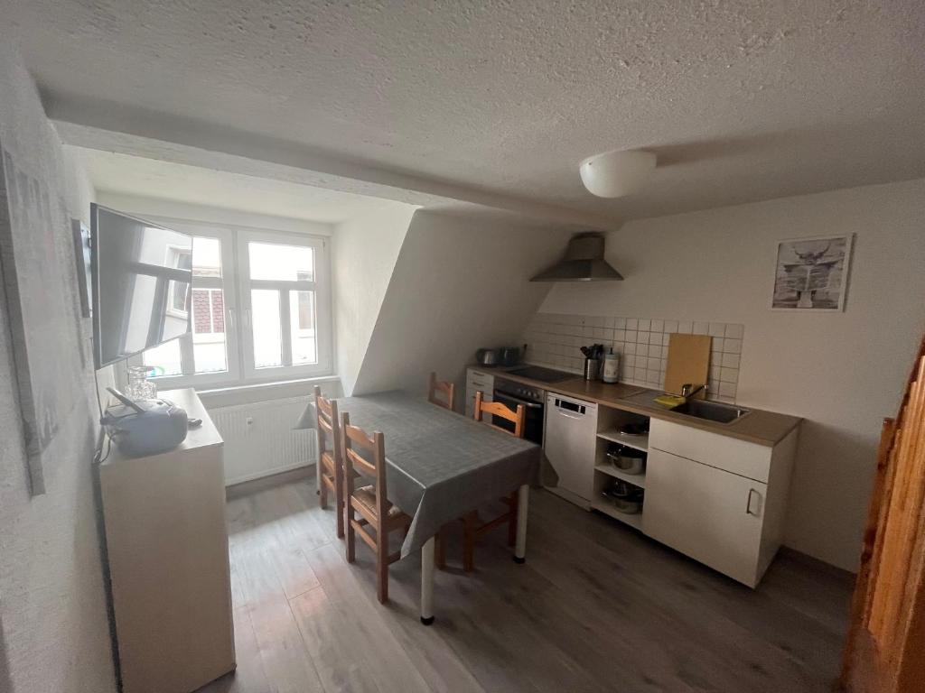 a kitchen with a table and a dining room at Ferienwohnung Zwätzi in Jena