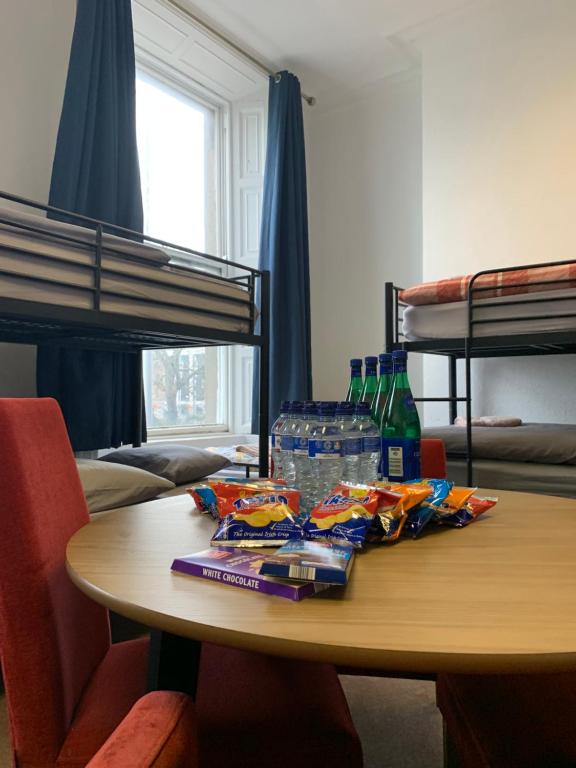 a table in a room with bunk beds at Eden Quay Guesthouse Private Rooms in Dublin