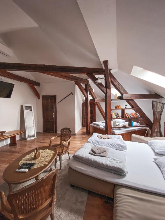a room with several beds and a table and chairs at Blue Lotus Hotel & Hostel in Bratislava
