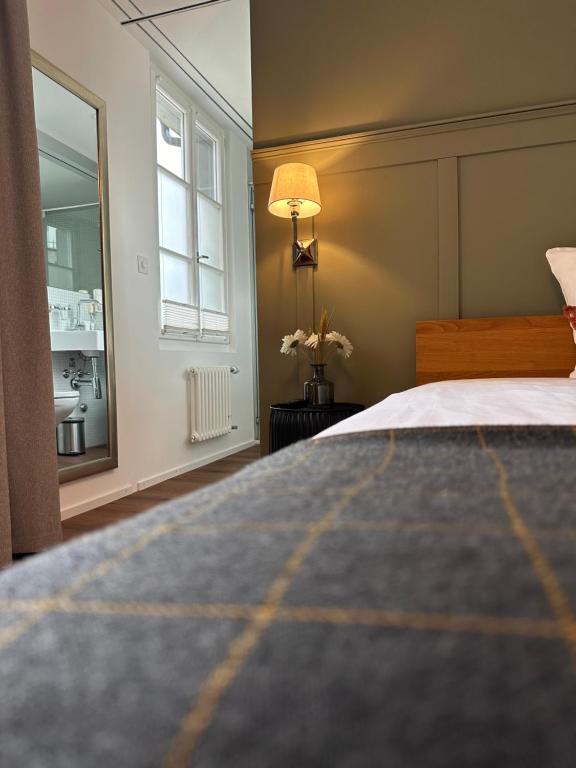 a bedroom with a large bed and a window at Peterhof Sarnen in Sarnen