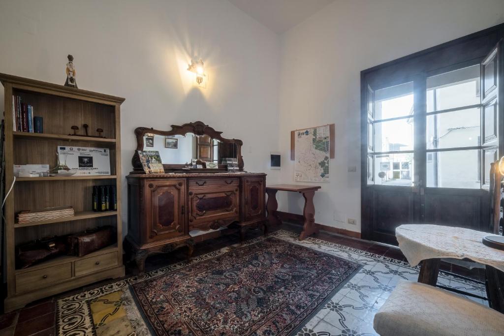 a living room with a wooden cabinet and a window at Casa Camboni-Dimora Storica Bed & Breakfast in San Vito