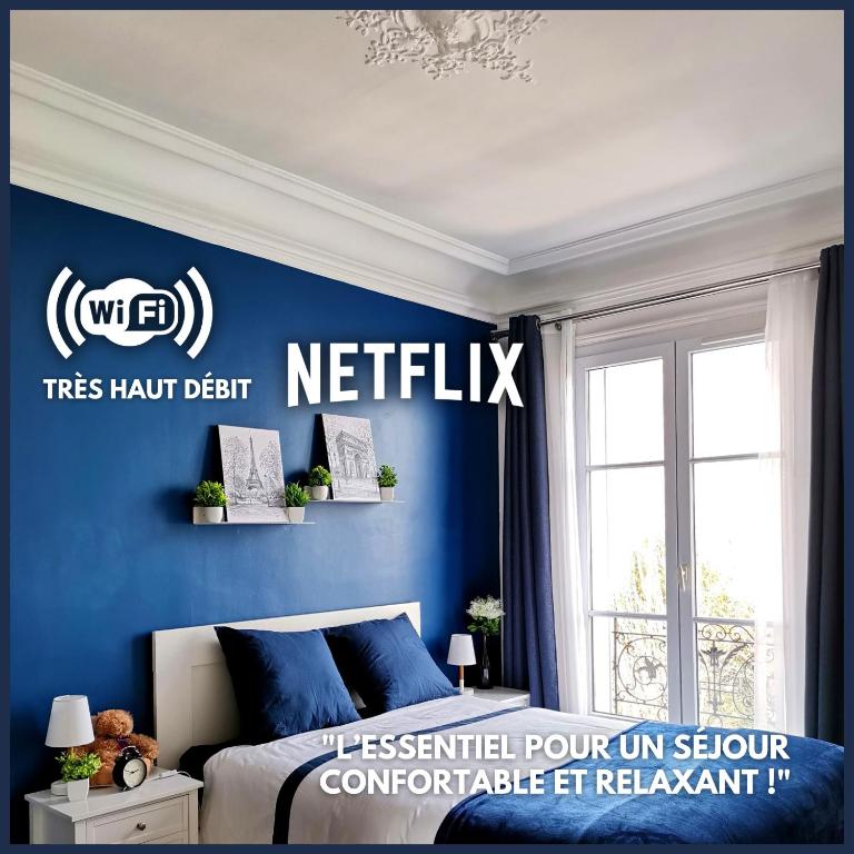 a bedroom with a blue wall with a sign on it at Perle Haussmannienne 1900 - Cosy - Centre ville in La Garenne-Colombes