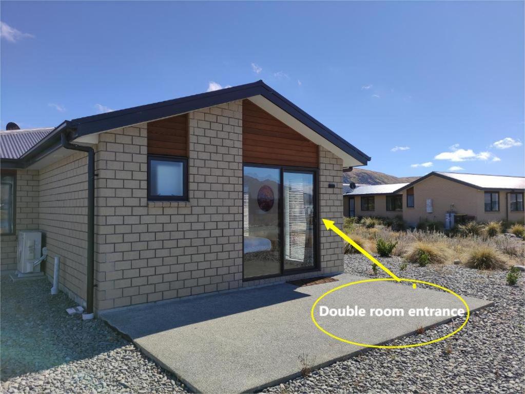 a house with a yellow hose in front of it at Twin Studio on Andrew Don Drive(Without Kitchen) in Lake Tekapo