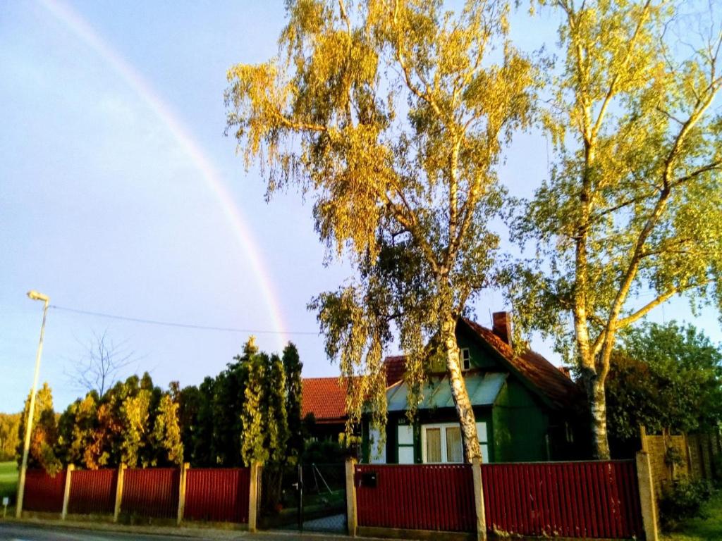 a rainbow over a house with a fence at Hexen Haus in Burghaslach