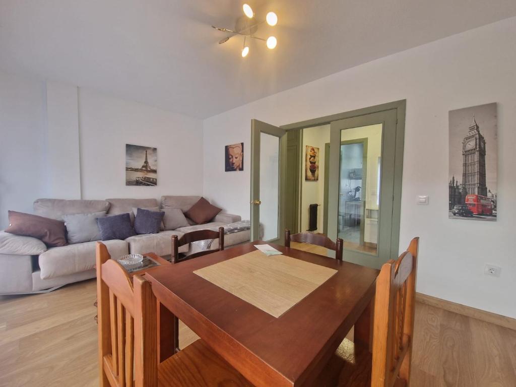 a living room with a table and a couch at Apartamento céntrico Llanes in Llanes