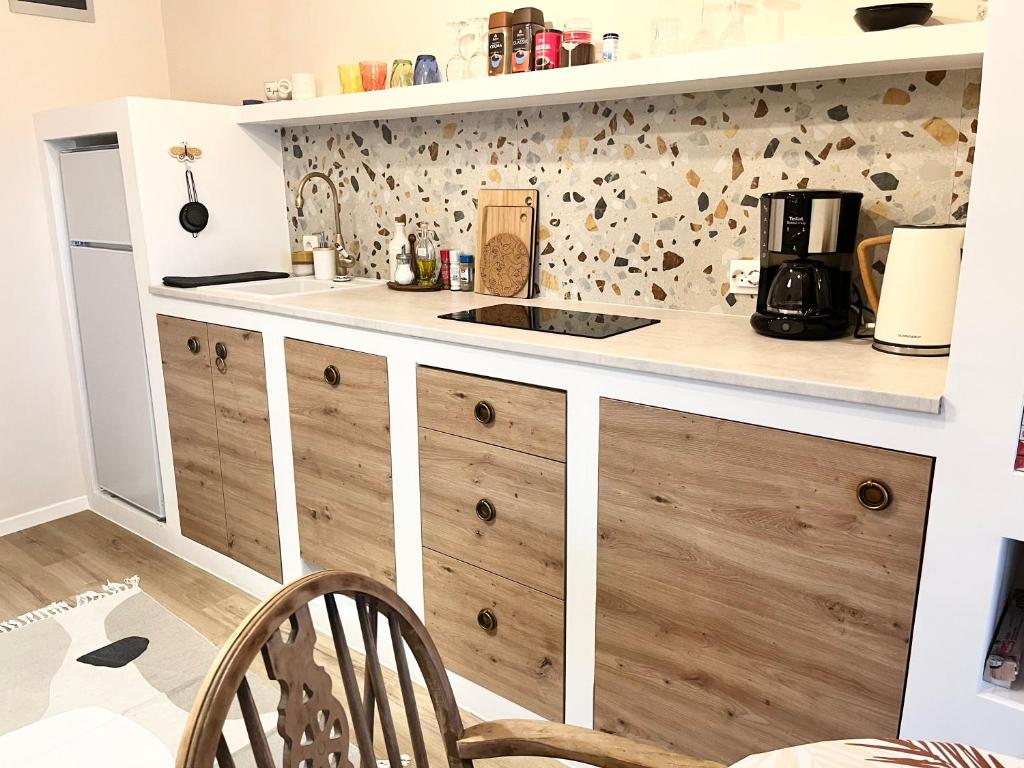 a kitchen with wooden cabinets and a counter top at Veronika's House in Pula