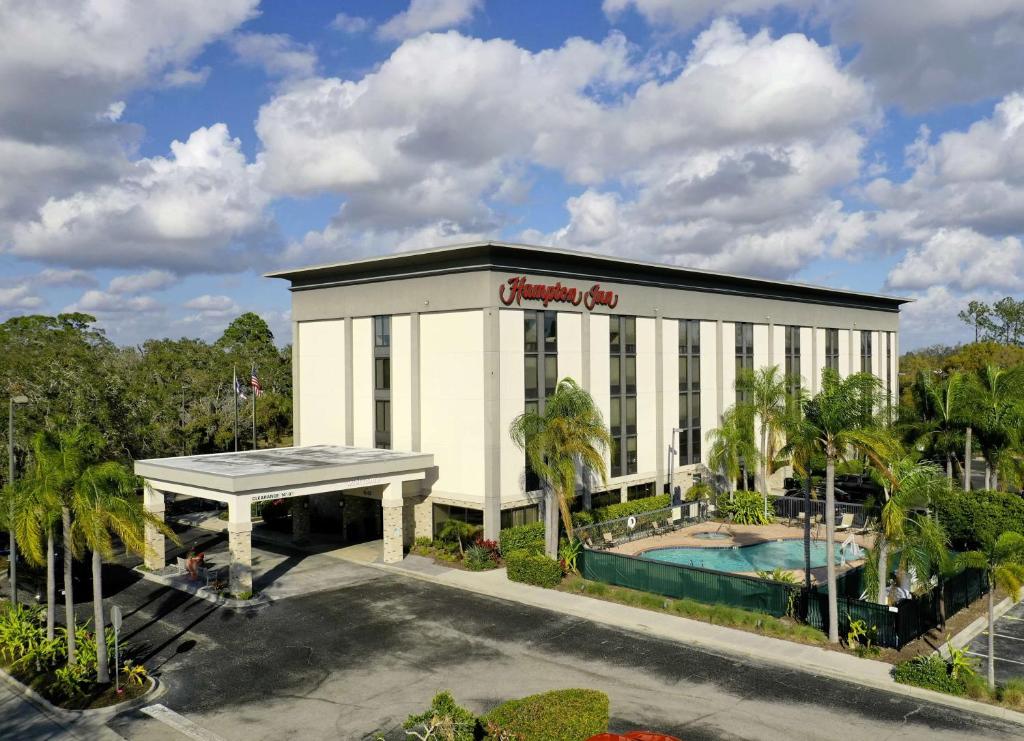 a large white building with a pool in front of it at Hampton Inn Sarasota I-75 Bee Ridge in Sarasota