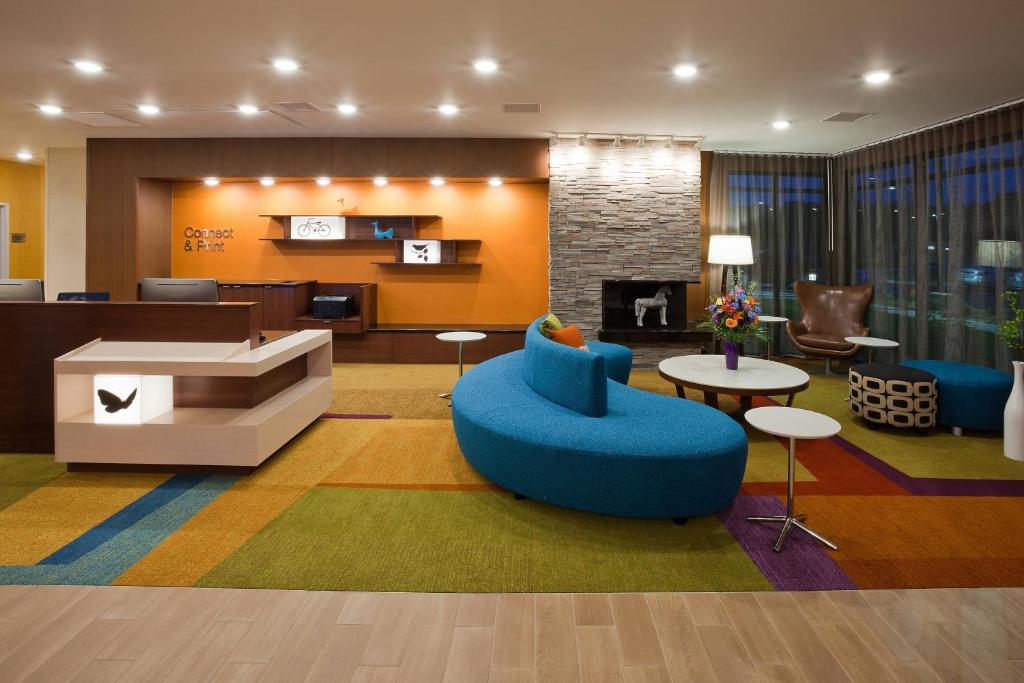a lobby with a couch and a chair and a table at Fairfield Inn & Suites by Marriott St. Paul Northeast in Vadnais Heights