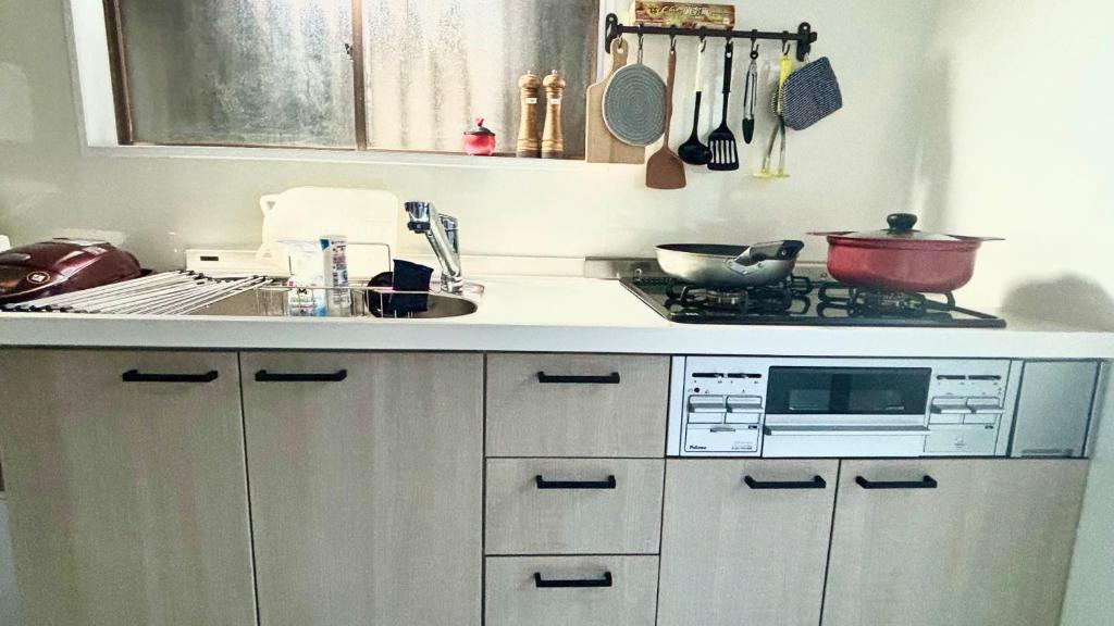 a kitchen with a sink and a stove top oven at Sunflower 2 in Tokyo