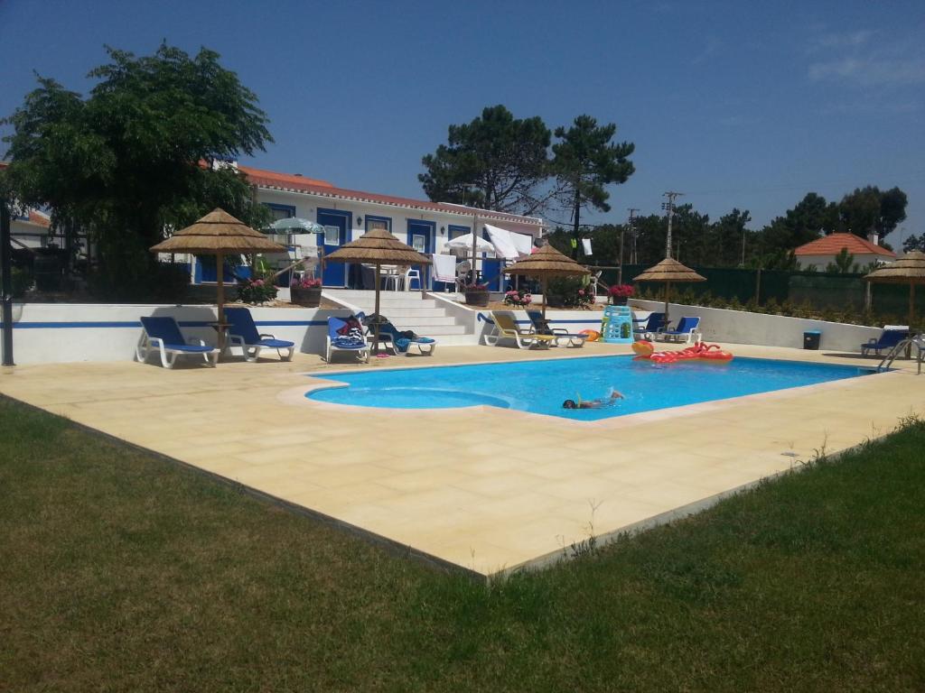 ein großer Pool mit einer Person, die darin liegt in der Unterkunft Monte Antonio Domingos in Melides