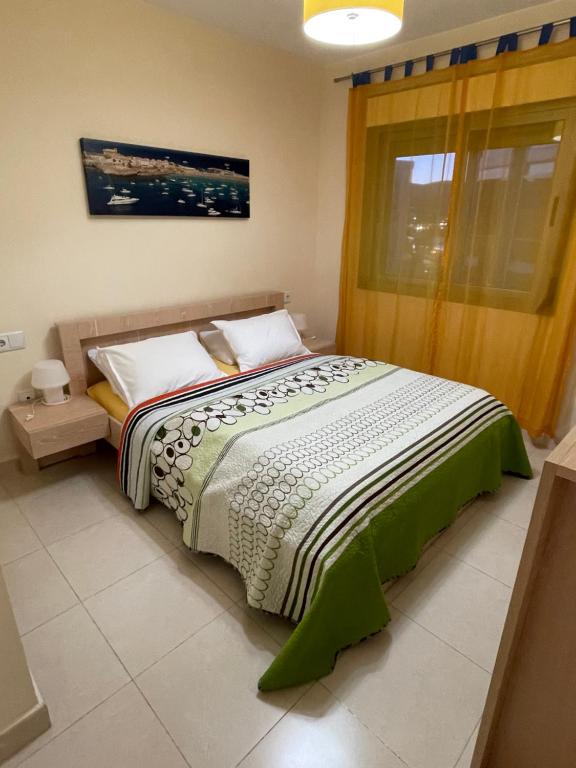 a bedroom with a large bed with a window at Apartment Bahia del Sol, a 20 m de Playa Arinal-Bol,Calpe in Calpe