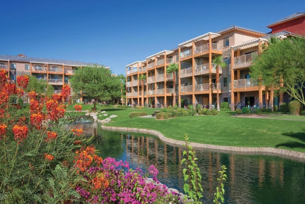 a resort with a pond in front of a building at Worldmark Indio in Indio