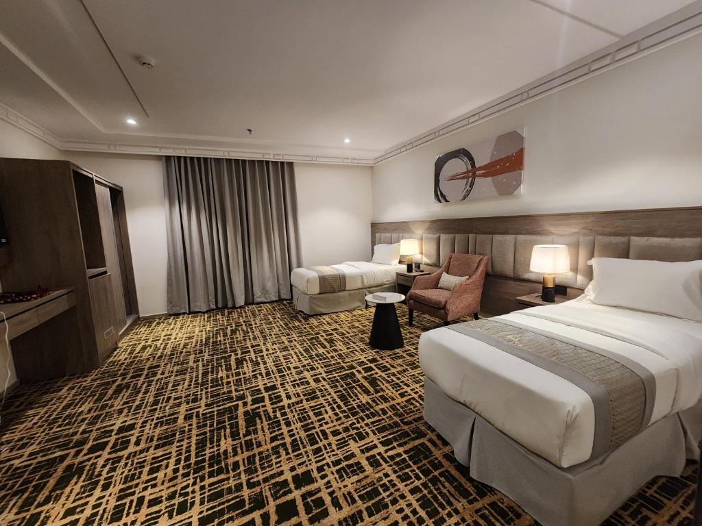 Postel nebo postele na pokoji v ubytování فندق كنف الشرائع - kanaf hotel Ash Sharāʼi