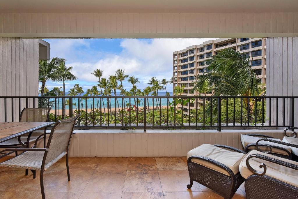 a balcony with a table and chairs and a view of the ocean at Kaanapali Alii 456 in Kaanapali