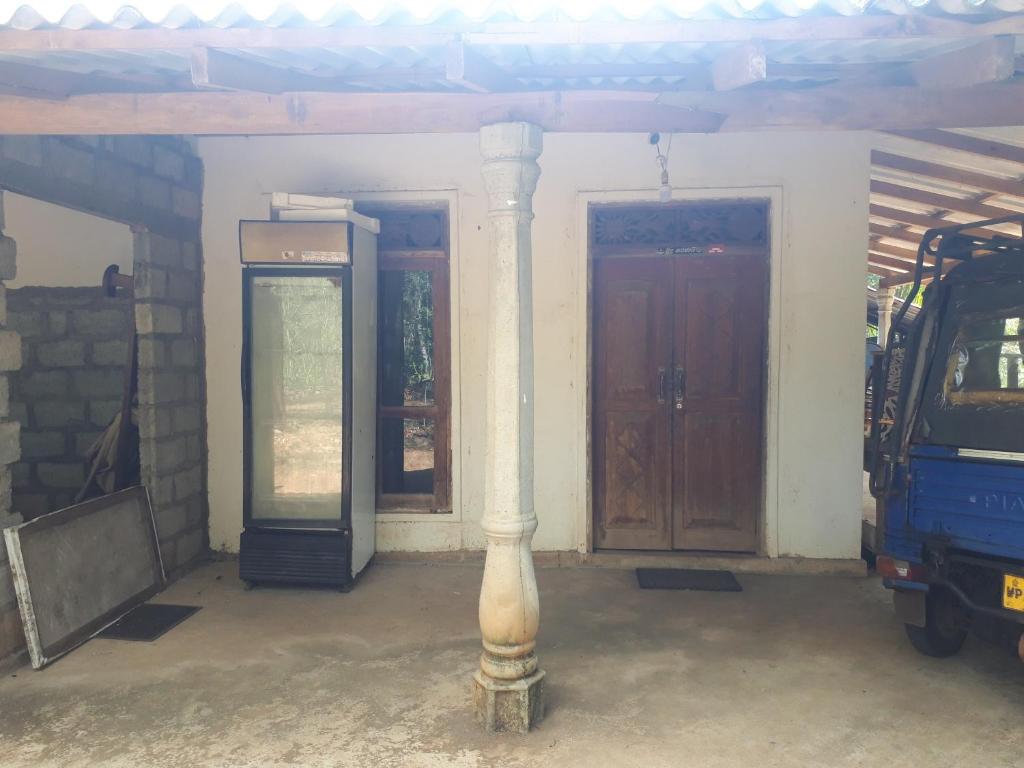 a column in front of a house with a door at Mountain view home stay in Mirigama