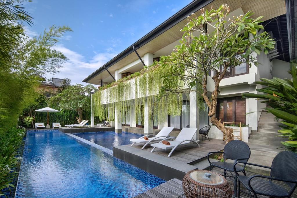 an image of a swimming pool in a house at AmantraNa Canggu in Canggu