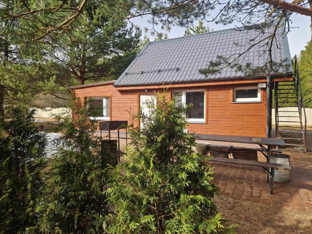 a tiny house with a bench in front of it at Домик с сауной для отдыха in Katase