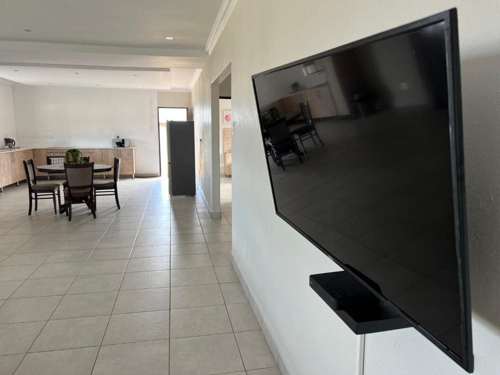a large flat screen tv on a wall in a living room at Numbigate Resort & Conference in Hazyview