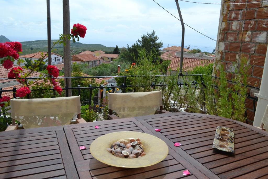 un piatto di rocce su un tavolo in legno sul balcone di Eliza Apartment Atheras a Athéras