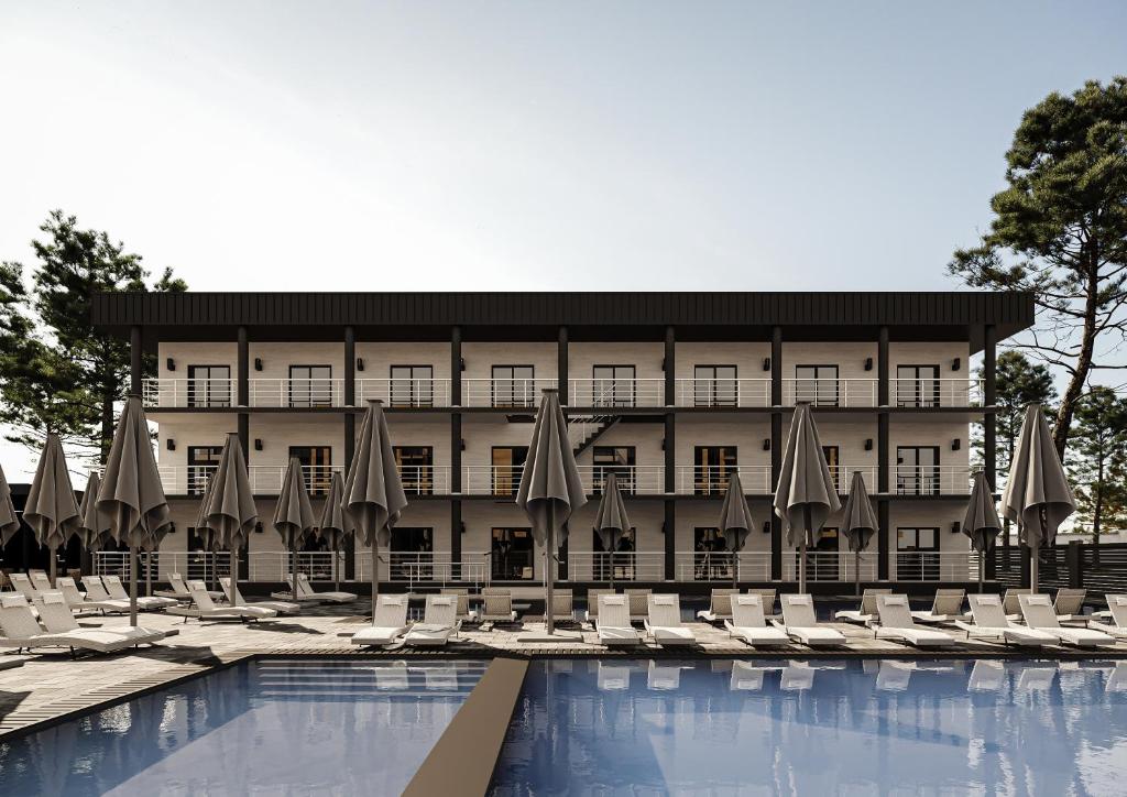 ein Hotel mit einem Pool mit Stühlen und Sonnenschirmen in der Unterkunft VILLA DIANA in Solotwyno