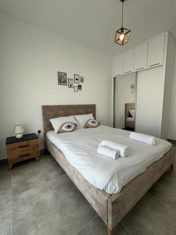 a bedroom with a large bed with eyes on it at Caesar Resort & SPA Commodus in Iskele