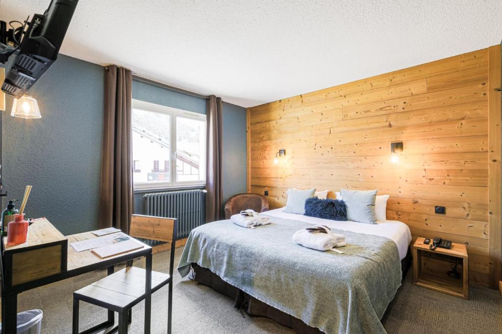 Postel nebo postele na pokoji v ubytování Hôtel et Spa les Clarines