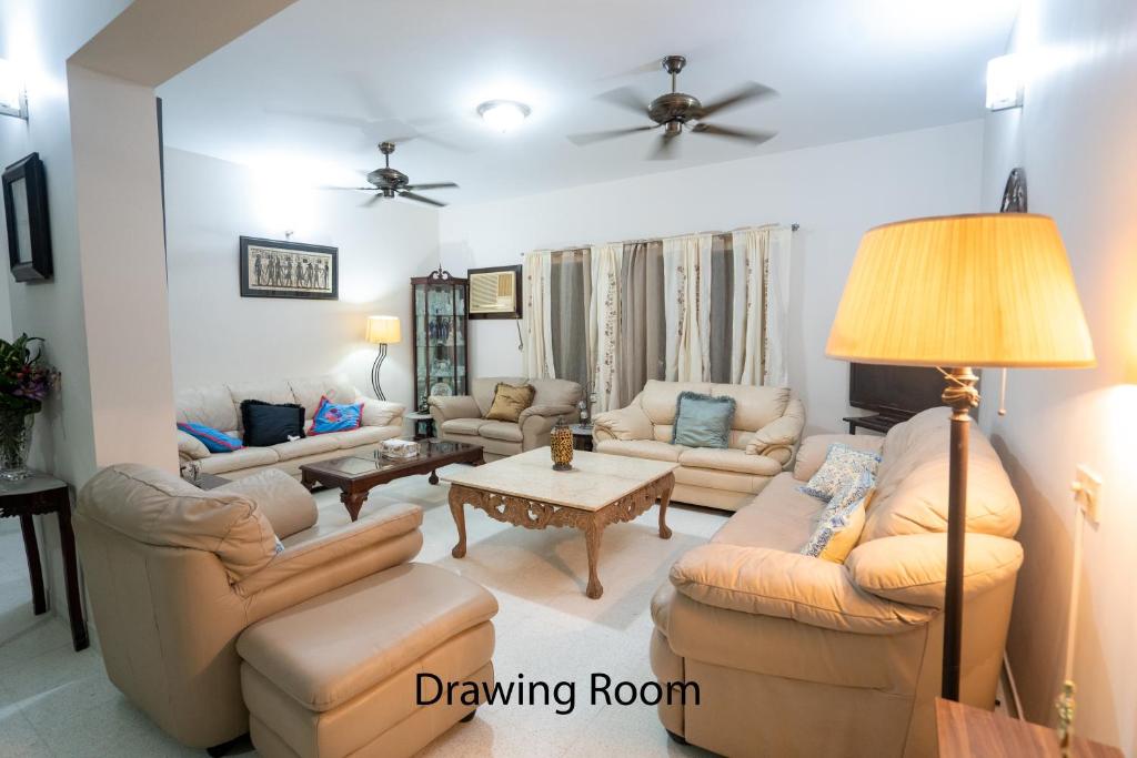 a living room with couches and a table at Swarloke Apartment at Gulshan 2,Dhaka in Dhaka