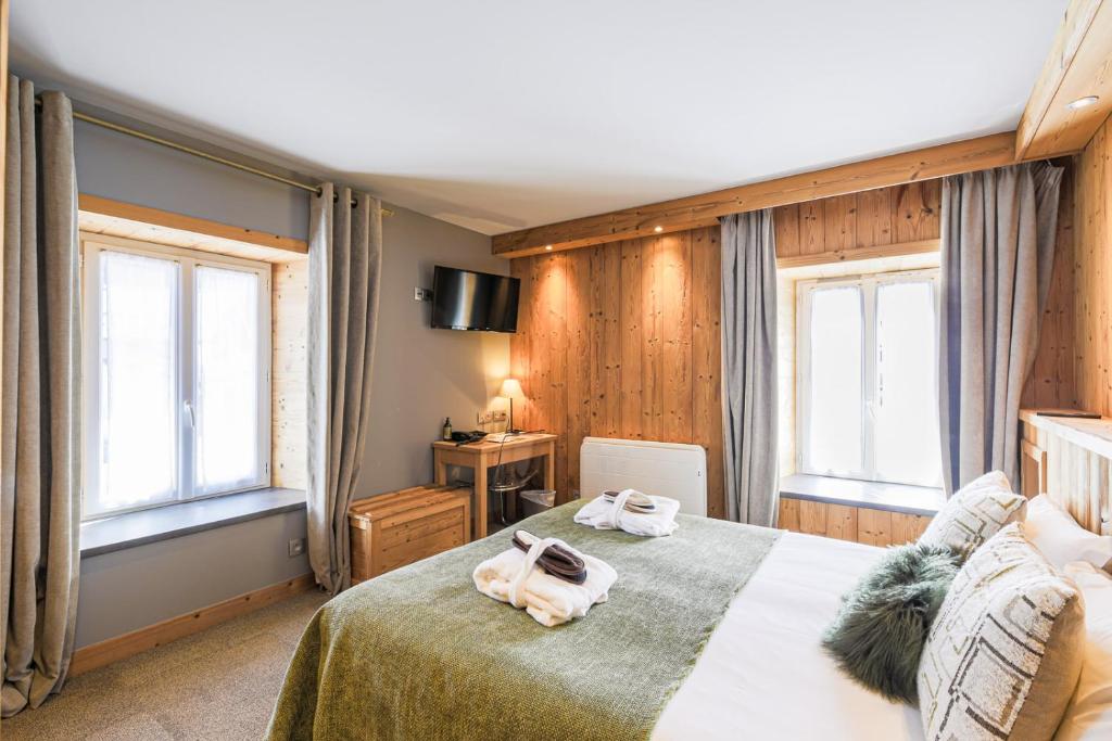 Postel nebo postele na pokoji v ubytování Hôtel et Spa les Clarines