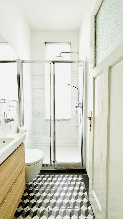a bathroom with a shower and a toilet and a sink at Jardin Rooms in Split