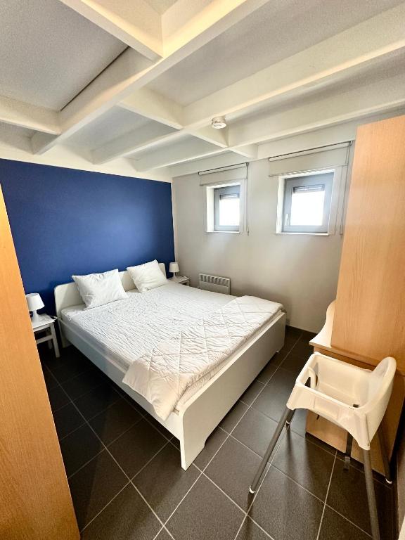 Postel nebo postele na pokoji v ubytování Zeepark Mercator